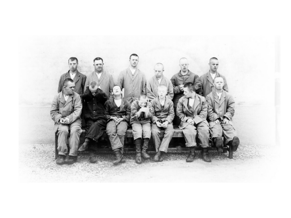 13 boys, everyone is dressed in gray clothes and leather shoes. Photo taken in the 1940's